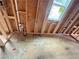 A bathroom under construction, featuring rough plumbing and a framed window at 1025 Liberty Springs Dr, Woodstock, GA 30188