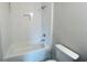 Elegant white tiled bathtub and shower combo in a modern bathroom with fixtures at 1025 Liberty Springs Dr, Woodstock, GA 30188