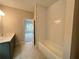 Bathroom featuring a modern tub/shower combo and view into another room, offering a relaxing space at 1025 Liberty Springs Dr, Woodstock, GA 30188