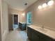 Well-lit bathroom featuring double vanities, stylish mirrors, and tiled floors, offering a modern aesthetic at 1025 Liberty Springs Dr, Woodstock, GA 30188