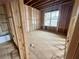 Bedroom under construction with wood framing and window offering natural light at 1025 Liberty Springs Dr, Woodstock, GA 30188