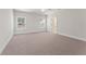 Spacious bedroom with neutral carpet, a ceiling fan, and a doorway to the bathroom at 1025 Liberty Springs Dr, Woodstock, GA 30188