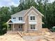 New construction home shows a charming brick facade with complementary gray trim and unfinished landscaping at 1025 Liberty Springs Dr, Woodstock, GA 30188