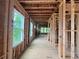 Unfinished hallway with wood framing, windows and natural light at 1025 Liberty Springs Dr, Woodstock, GA 30188