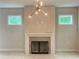 Living room with an electric fireplace, statement lighting, and dual windows bringing in natural light at 1025 Liberty Springs Dr, Woodstock, GA 30188