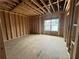 Empty room under construction, showcasing the wood framing, window, and natural light at 1025 Liberty Springs Dr, Woodstock, GA 30188