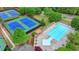 Aerial view featuring community pool and tennis courts, perfect for recreation and leisure at 1263 Whisperwood Ln, Lawrenceville, GA 30043
