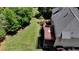 Aerial view of the property showcasing the expansive backyard, multi-level deck, and surrounding trees at 1263 Whisperwood Ln, Lawrenceville, GA 30043