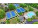 Aerial view of a community pool, tennis courts, clubhouse, playground and parking lot at 1263 Whisperwood Ln, Lawrenceville, GA 30043