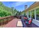 Wide shot of back deck featuring seating, a lovely view of the trees, and a peek at the home at 1263 Whisperwood Ln, Lawrenceville, GA 30043