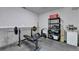 Unfinished basement space featuring a weight bench, storage shelving, and white walls at 1263 Whisperwood Ln, Lawrenceville, GA 30043