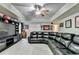 Basement features a large black sectional sofa, TV, and sports themed decor at 1263 Whisperwood Ln, Lawrenceville, GA 30043