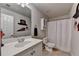 Bright bathroom featuring a vanity with ample counter space and a shower with a white curtain at 1263 Whisperwood Ln, Lawrenceville, GA 30043