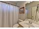 Neutral bathroom featuring a shower with curtain, a sink with a vanity, and a toilet at 1263 Whisperwood Ln, Lawrenceville, GA 30043