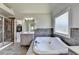 Luxurious bathroom with whirlpool tub, walk-in shower, and tiled floors, and a walk-in closet at 1263 Whisperwood Ln, Lawrenceville, GA 30043