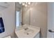 Bathroom features vanity, sink, mirror, light fixture, towel, and door at 1263 Whisperwood Ln, Lawrenceville, GA 30043