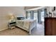 Bedroom features a plush bed, windows, and charming side tables at 1263 Whisperwood Ln, Lawrenceville, GA 30043