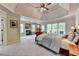 Spacious main bedroom with a tray ceiling, fireplace, and access to a private balcony at 1263 Whisperwood Ln, Lawrenceville, GA 30043