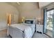 Bedroom featuring a cozy bed, neutral carpeting, and plenty of natural light at 1263 Whisperwood Ln, Lawrenceville, GA 30043