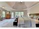 Spacious primary bedroom with large windows and a private balcony, featuring a trey ceiling at 1263 Whisperwood Ln, Lawrenceville, GA 30043