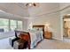 Spacious main bedroom with a tray ceiling and access to a private balcony at 1263 Whisperwood Ln, Lawrenceville, GA 30043