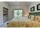 Bedroom features a large window, built-in bookshelves, bed with decorative pillows, and two framed pictures on the wall at 1263 Whisperwood Ln, Lawrenceville, GA 30043