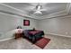 Cozy bedroom with tray ceilings, sports decor, neutral walls, and tile flooring at 1263 Whisperwood Ln, Lawrenceville, GA 30043