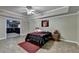 Comfortable bedroom featuring a ceiling fan, unique flooring, sports decor, and access to other rooms at 1263 Whisperwood Ln, Lawrenceville, GA 30043