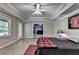 Bedroom with a ceiling fan, sports decor, access to backyard, and an open layout to a living space at 1263 Whisperwood Ln, Lawrenceville, GA 30043