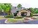 Community clubhouse featuring stone accents, a covered entrance, and professional landscaping at 1263 Whisperwood Ln, Lawrenceville, GA 30043