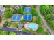 Aerial view showcasing a community pool, tennis courts, clubhouse, playground and parking lot at 1263 Whisperwood Ln, Lawrenceville, GA 30043