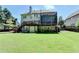 Rear exterior view showing expansive lawn, a two-story deck, basement access, and well-maintained landscaping at 1263 Whisperwood Ln, Lawrenceville, GA 30043