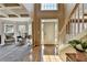 Sun-lit foyer showcasing hardwood floors and a view into the living room with a coffered ceiling at 1263 Whisperwood Ln, Lawrenceville, GA 30043