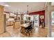 Bright kitchen with stainless steel appliances, center island, wooden cabinetry, and adjacent dining area at 1263 Whisperwood Ln, Lawrenceville, GA 30043