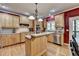 Bright kitchen with stainless steel appliances, light wood cabinetry, and an island workstation at 1263 Whisperwood Ln, Lawrenceville, GA 30043
