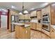 The kitchen is a spacious design with light wood cabinetry, and stainless steel appliances at 1263 Whisperwood Ln, Lawrenceville, GA 30043