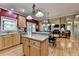 This kitchen features light wood cabinetry, stainless steel appliances, and a center island at 1263 Whisperwood Ln, Lawrenceville, GA 30043
