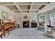 Cozy living room showcasing coffered ceilings, a fireplace, and elegant decor for comfortable living at 1263 Whisperwood Ln, Lawrenceville, GA 30043