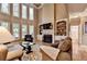 Living room with soaring ceilings, large windows, a fireplace and built-in bookshelves at 1263 Whisperwood Ln, Lawrenceville, GA 30043