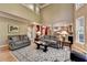 Open-concept living space with soaring ceilings, hardwood floors, and seamlessly connected to the kitchen area at 1263 Whisperwood Ln, Lawrenceville, GA 30043