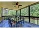 Inviting screened patio area with a decorative ceiling fan and a stylish dining set at 1263 Whisperwood Ln, Lawrenceville, GA 30043