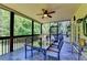 Screened patio featuring an outdoor dining setup and views of the greenery and backyard at 1263 Whisperwood Ln, Lawrenceville, GA 30043