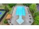 Aerial view of a community pool featuring lounge chairs, tables, and a pergola covered seating area at 1263 Whisperwood Ln, Lawrenceville, GA 30043