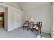 Room features a large window with natural light, two chairs, a lamp, a cabinet, and double doors at 1263 Whisperwood Ln, Lawrenceville, GA 30043