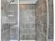 Modern tile shower featuring sleek fixtures, shower heads, and a glass door at 1263 Whisperwood Ln, Lawrenceville, GA 30043