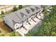 Overhead view showcases townhomes with individual garages, tidy landscaping, and neutral color palette at 137 White Mountain Pass, Mcdonough, GA 30252
