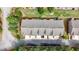 An aerial view shows roofs and driveways nestled among lush trees and landscaping at 137 White Mountain Pass, Mcdonough, GA 30252