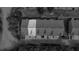 Black and white aerial view of roofs and driveways nestled amid lush trees at 137 White Mountain Pass, Mcdonough, GA 30252