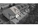 An aerial view of townhomes showcasing a modern design and attached garages in black and white at 137 White Mountain Pass, Mcdonough, GA 30252