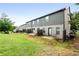 View of townhome backyards with grass and small patios, and limited fencing between units at 137 White Mountain Pass, Mcdonough, GA 30252